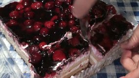 Female hand cuts off a piece of cherry cake. HD 1920x1080 Video Clip