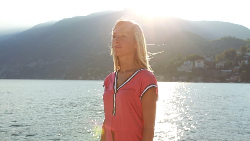 Cheering woman arms raised by the lake at sunset-Summer
Young woman standing on rocks by the lake Maggiore edge arms outstretched for freedom and success. Sunset on the alps in Switzerland.