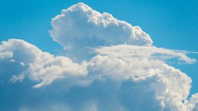 Timelapse of white puffy, fluffy, cumulus clouds rolling, flying, passing, fast moving blue sky at cloudy summer day, motion video footage in 4096x2304 4K resolution, good as nature background