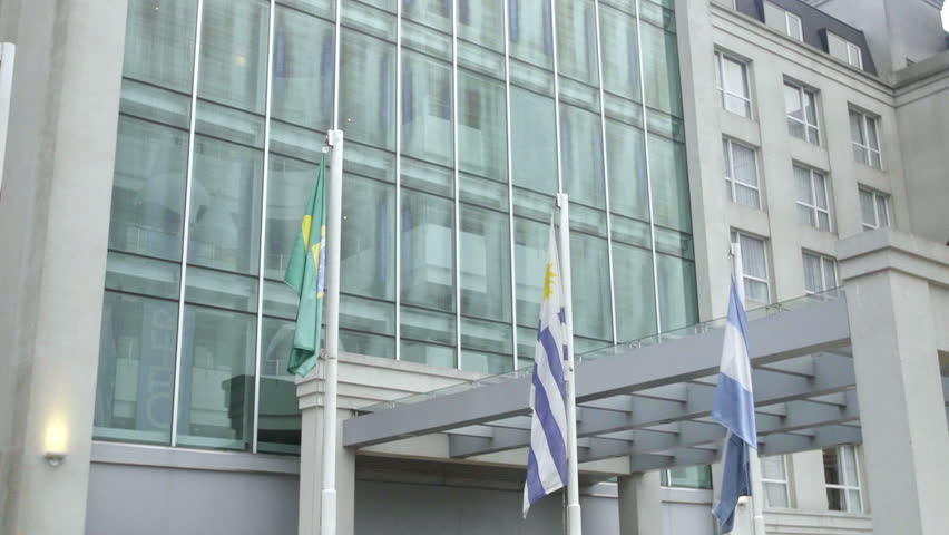 International flags wave in the breeze in front of a luxury hotel in Buenos Aires, Argentina