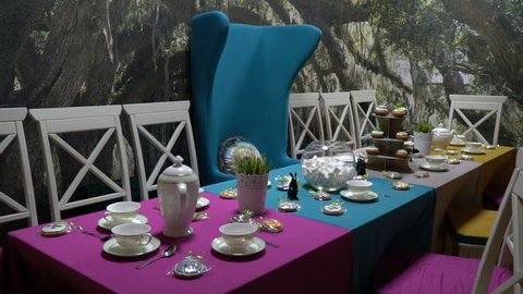 Blue armchair near the table with desserts and tea service