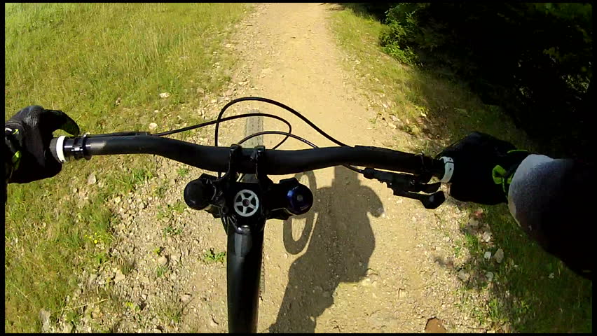 Downhill front view. Ride a bike over terrain pov. 