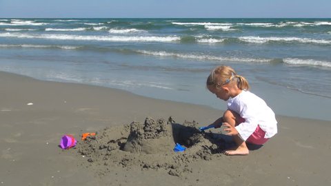 Child Playing on the Beach, Little Girl Having Fun with a Sand Castle