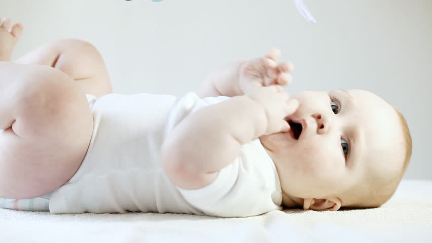 Smiling baby on the light background