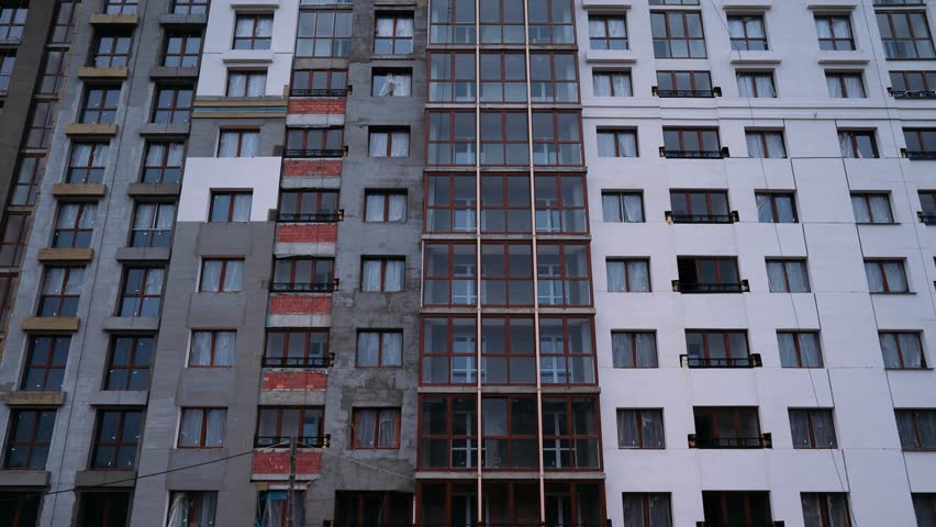 Timelapse. Construction, a view of the construction of a residential building, building elevators are moving along the building's facade. Workers build a house.  | Shutterstock HD Video #27820153