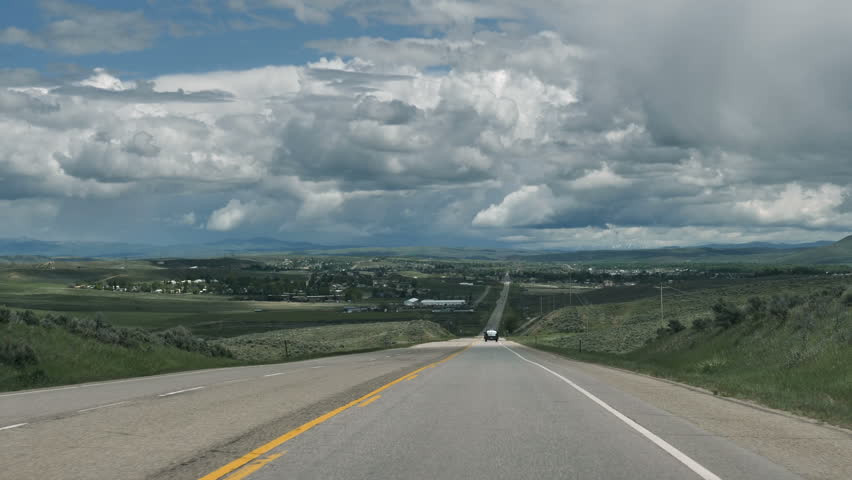 Drive Plate-POV-View forward-Looking down hill approaching the town of Craig in the northwest part of Colorado in Moffat County.