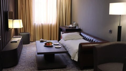 YEREVAN - JAN 5, 2017: Light turns on and off in room with sofa and coffee table in the Hotel National. Business-class National Hotel, part of the international group Luxury Group, was opened in 2012