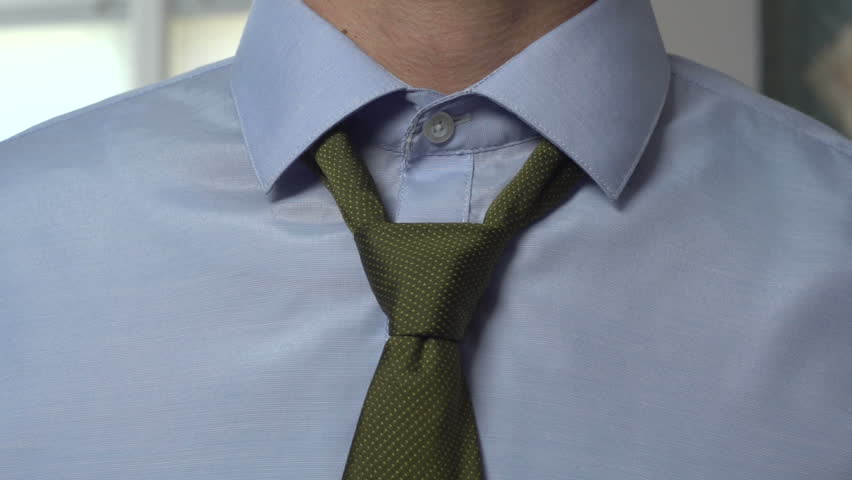 Man tying necktie, close up