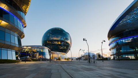ASTANA, Kazakhstan - June 10, 2017: Timelapse of modern sphere building of EXPO with people moving around on sunset