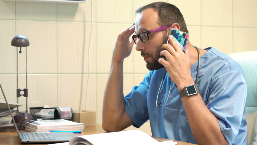 Angry, upset doctor with laptop and documents talking on cellphone in office
 Royalty-Free Stock Footage #27829816