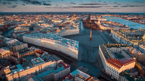Aerial shot of the Palace Square and Alexander Column at sunset, a gold dome of St. Isaac's Cathedral, the Winter Palace, the Hermitage. St. Petersburg. Russia