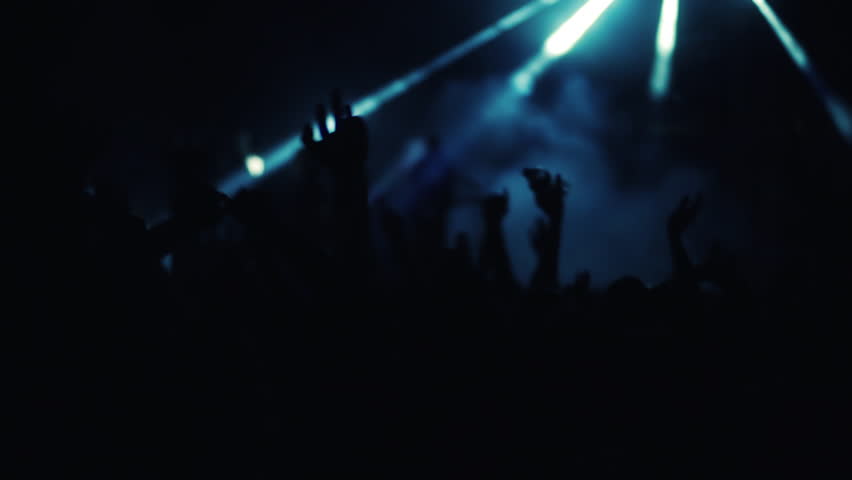Enthusiastic front row crowd cheering hands in air slomo 100p.An outdoor summer night rock concert.People cheer move lift and clap their hands in unison against the strobing stage lights. Royalty-Free Stock Footage #27834724