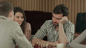 Young men playing chess with friends