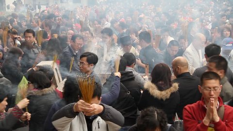 GUANGZHOU - FEBRUARY 3: People burn incense in temple during Chinese New Year on February 3, 2011 in Guangzhou, China.