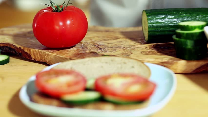 slicing tomatoes and cucumber