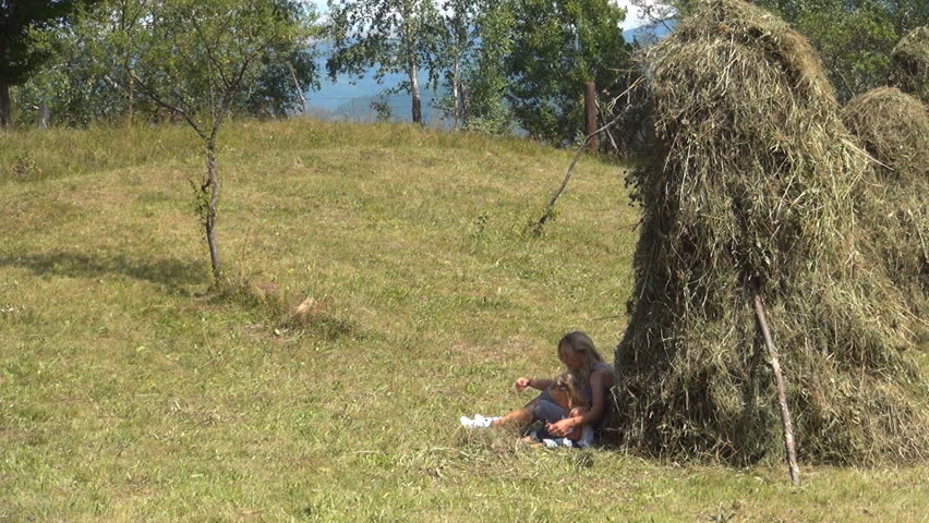 Mother and Child Smelling, Playing, and Collecting Mountain Flowers by a Haycock, Family Resting by a Haycock in the Mountains