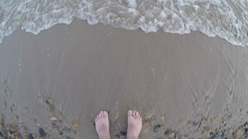 POV: Man standing in the shallow sea water