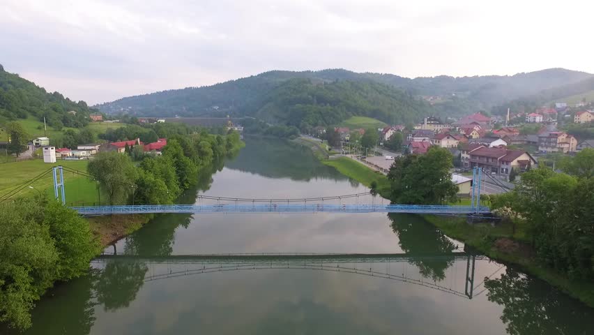 Flight over the Wisla river above the bridge and the dam. Bielsko-bials, Poland. 