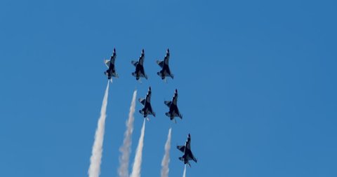 TITUSVILLE, FLORIDA - CIRCA MARCH 2017: USAF Thunderbirds Demonstration Team performs at airshow - six jets flying upwards in tight formation with smoke trails in slow motion