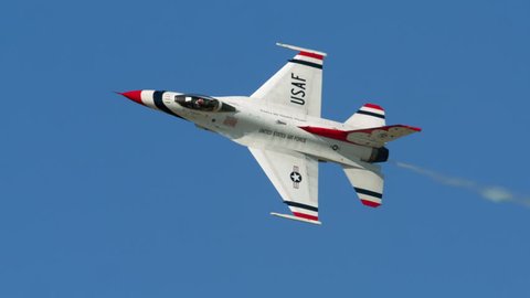 TITUSVILLE, FLORIDA - CIRCA MARCH 2017: USAF Thunderbirds Demonstration Team performs at airshow - close-up of jet flying on side in super slow motion