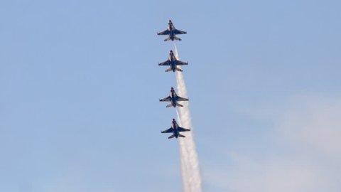 TITUSVILLE, FLORIDA - CIRCA MARCH 2017: USAF Thunderbirds Demonstration Team performs at airshow - four F18 Hornet jets flying vertically in tight formation in super slow motion