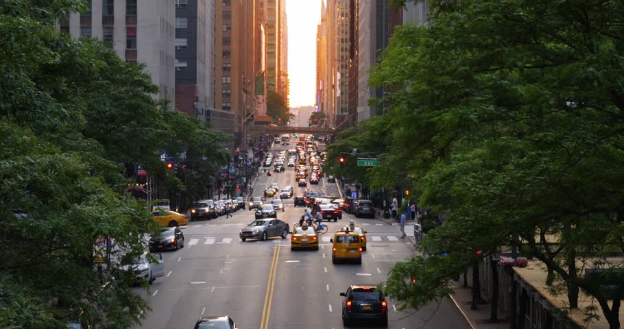 A slow motion evening establishing shot looking down 42nd Street in midtown Manhattan at sunset. Shot at 48fps.
 Royalty-Free Stock Footage #27855160