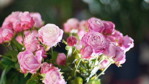 close-up, Flower bouquet in the rays of light, rotation, the floral composition consists of pink roses, Divine beauty
