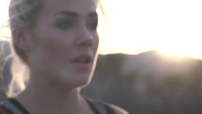 Female athlete heavy breathing, wipe nose, slow motion face closeup at sunset in desert. HD video