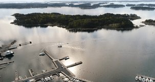 Speedboat, Cinema 4k aerial view around a motor boat leaving the kasnas harbor in the finnish archipelago, in Varsinais-suomi, Finland