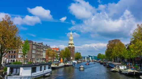 Amsterdam 4K Hyperlapse with Canal Houses, fast moving clouds and a tower on the background. This tower is located close to central station and the famous red light district.