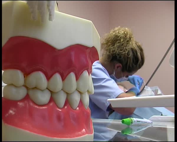 LUGANSK JUNE 8: Central hospital. 	 Dentist treats a tooth against the backdrop of the jaw.