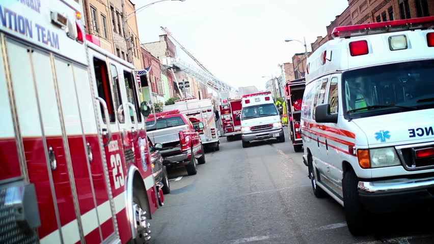 Emergency vehicles line the street at a 10-alarm fire on a small town's main