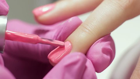Step of professional gel polish manicure closeup footage. Female master in the salon makes a spa procedure for the fingernails of the client. Beauty industry, relax concept.