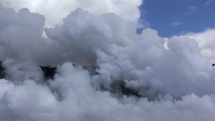 View of lava flowing into the ocean from the Hawaiian Boat Tour. Kilauea Volcano, Hawaii Big Island, USA.