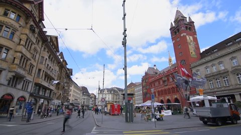 Basel, May 12: Timelapse view of the marketplace of Basel with trams, the city hall and people walking around. The city hall in Basel is over 500 years old. Shot at the 12 May 2017. 