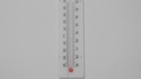 Thermometer on a white background, the temperature rises. UltraHD stock footage.