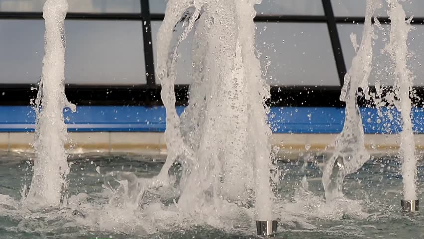 Water drops splashing on water surface.Close up of fountain. Powerfull water stream. background. Shinning splash of . jet splashing on water surface