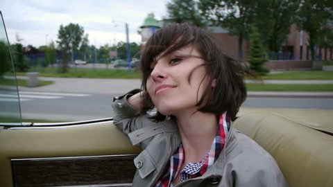 beautiful smiling brunette rides in a back seat of a convertible car freedom concept
 Stock Video