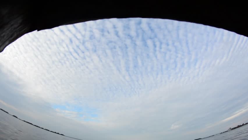 A boy jumps from a wooden pier into the water