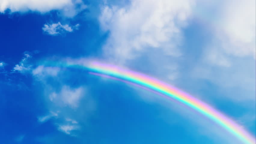 Rainbow revealed by clouds in sky time lapse  Royalty-Free Stock Footage #27893020