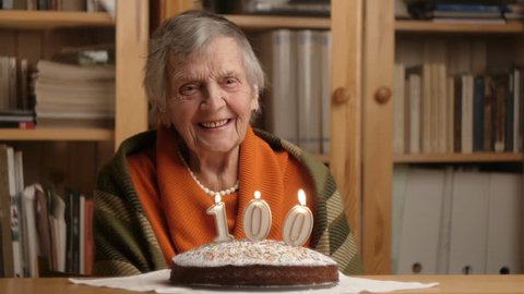 very happy grandmother laughing at her 100th birthday cake
 Stock Video