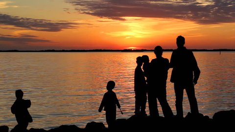 Family on a shore at sunset
