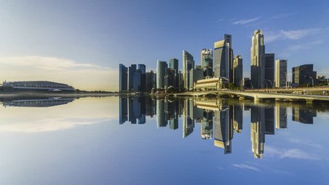 SINGAPORE, JANUARY 2017: City Skyline view across Marina Bay to the Financial and Business district of Singapore with clear blue sky. 4K. Motion Time lapse Zoom In.