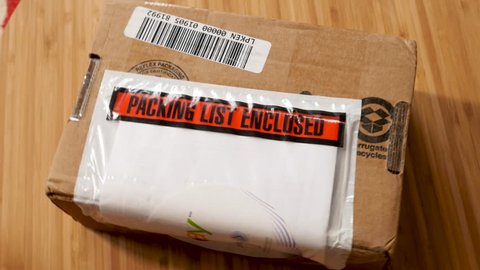 Packaging list enclose man unboxing cardboard box received by post after an online purchase experience