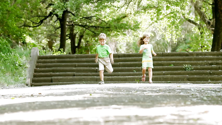 Two children running in park, outdoors