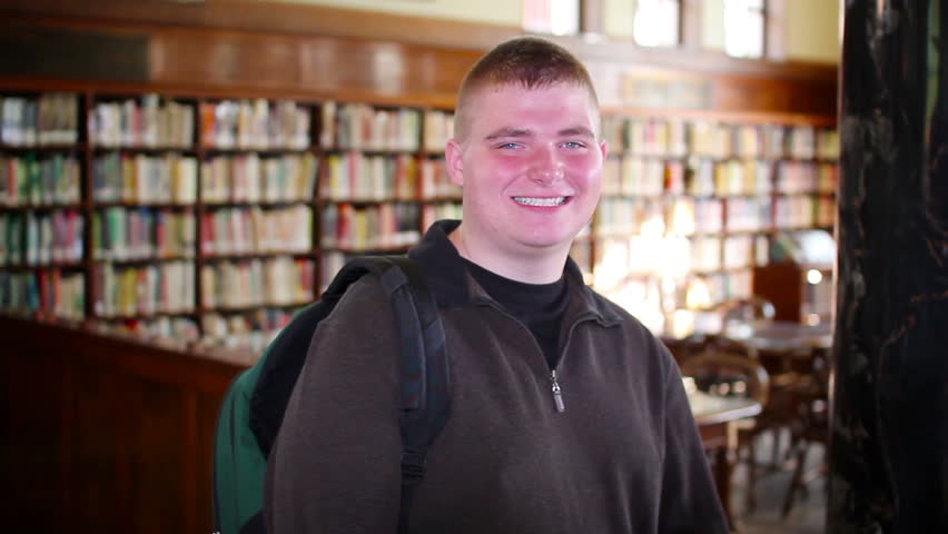 A confident male student looks at the camera.