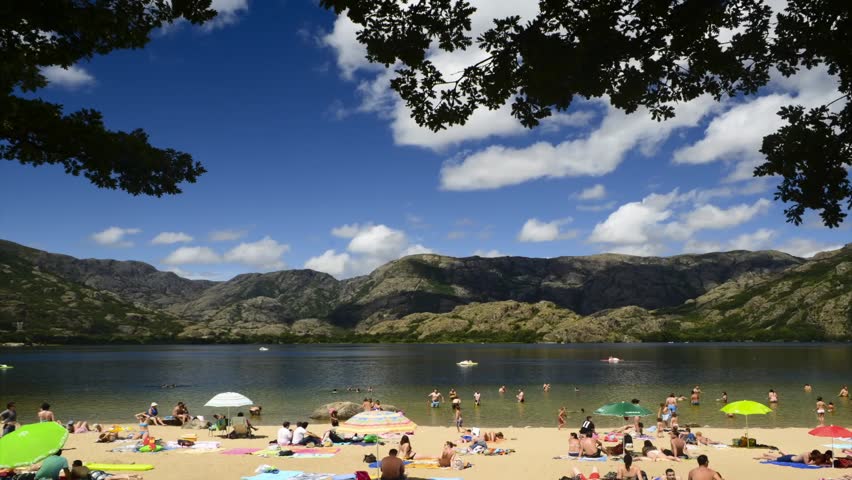 SANABRIA, SPAIN - CIRCA 2012: Time lapse of people in the beach of Sanabria Lake