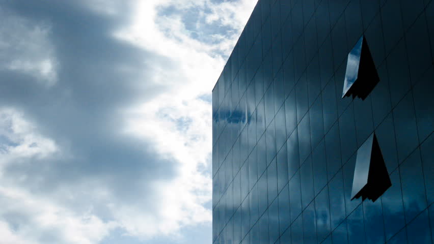 MADRID, SPAIN- CIRCA 2011: Time lapse of clouds flying over a glassy modern