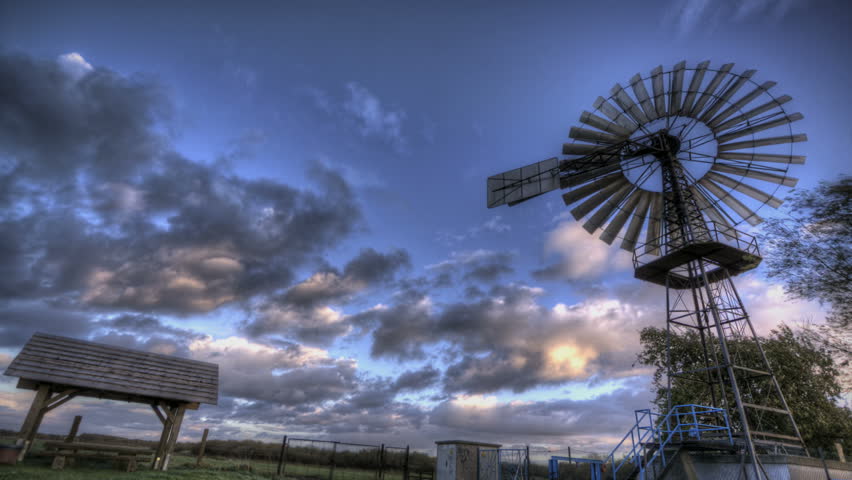 HDR Time lapse vintage wind turbine and clouds passing by 