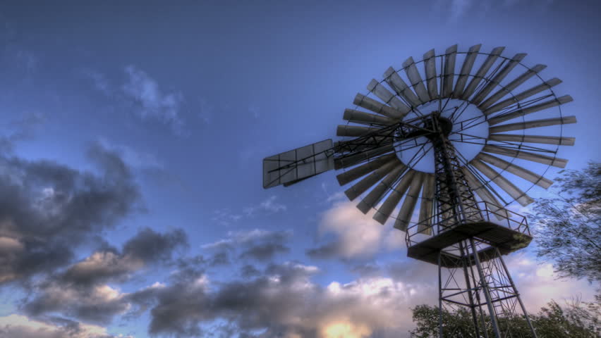 HDR Time lapse vintage wind turbine and clouds passing by 